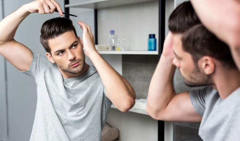 man-combing-hair-in-mirror.png